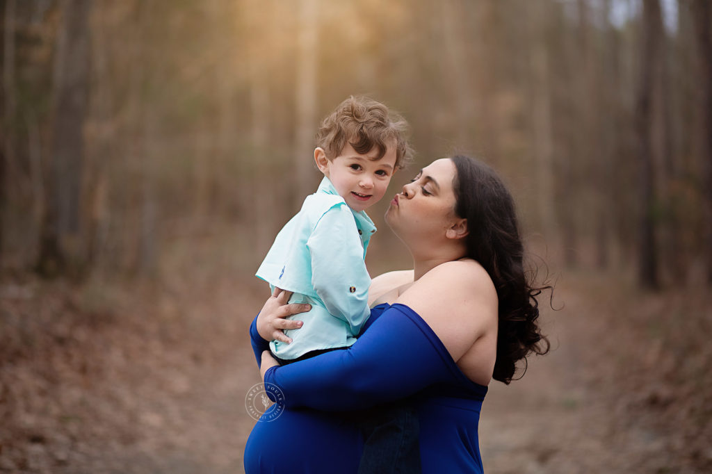 selecting your maternity photographer mom and son in forest