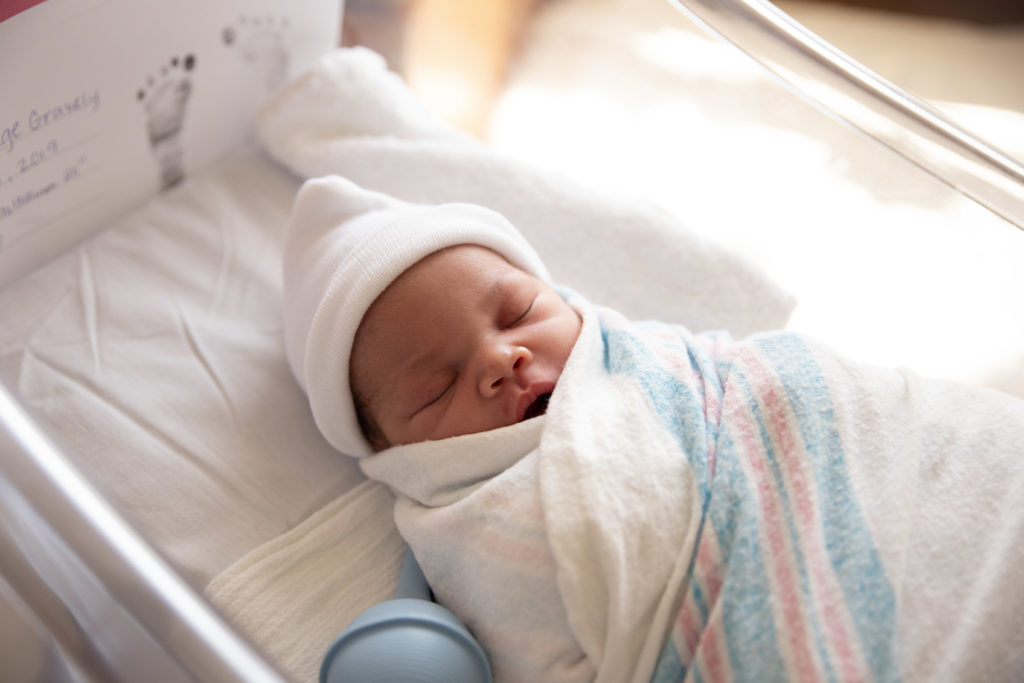 fresh 48 session newborn baby in hospital bassinet