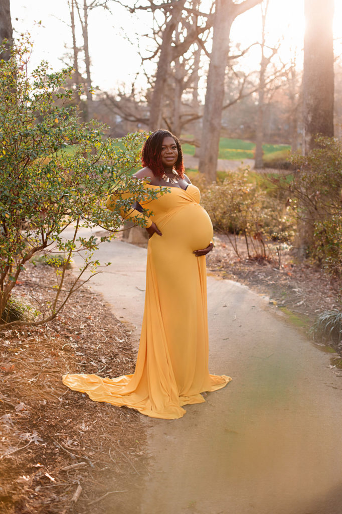 pregnant mom standing on path at glencairn garden