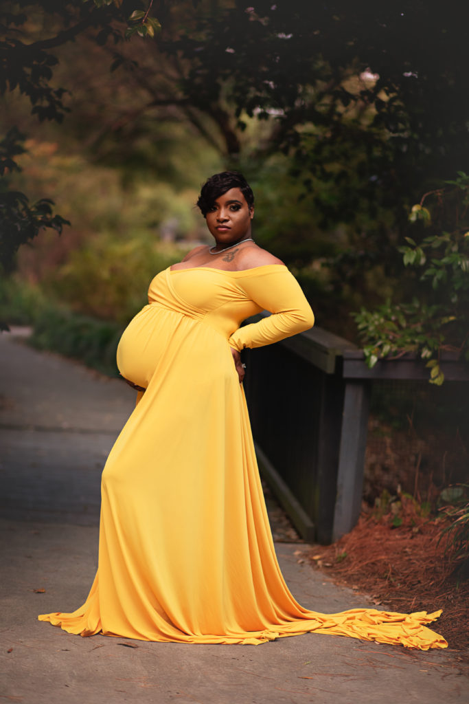 pregnant woman back arched showing off baby bump glencairn garden maternity session
